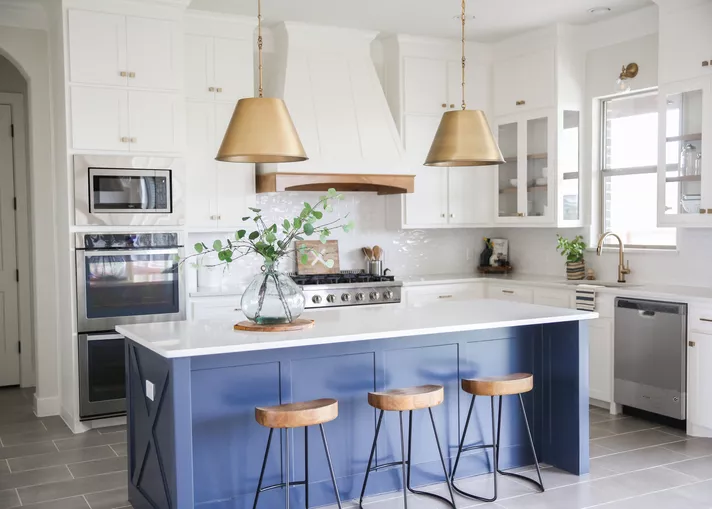 White kitchen with blue accent island color