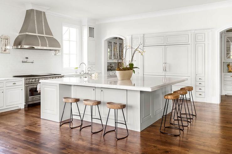 Large island in a white kitchen with plenty of seating