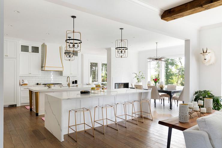 White And Bright Kitchen With Waterfall Quartz Countertop That Looks Like Marble