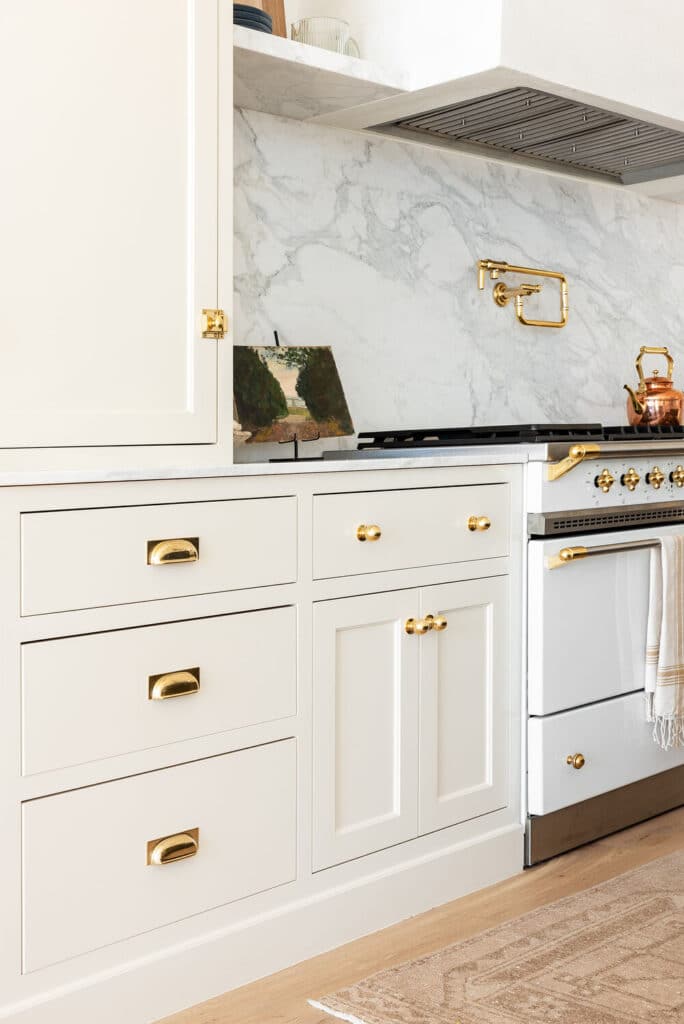 Large High-End Range And Hood With Marble Backsplash