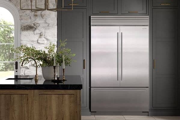 Built-in Sub-Zero refrigerator in a grey kitchen