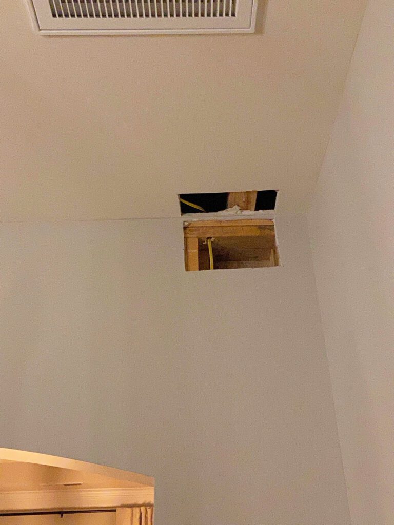 Drywall hole from wiring a new light fixture in a room without wiring