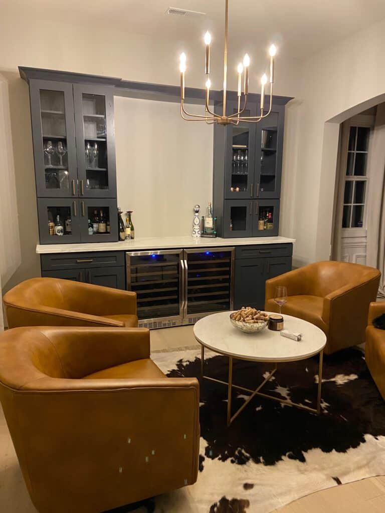 Upper cabinets installed in home bar with chandelier light