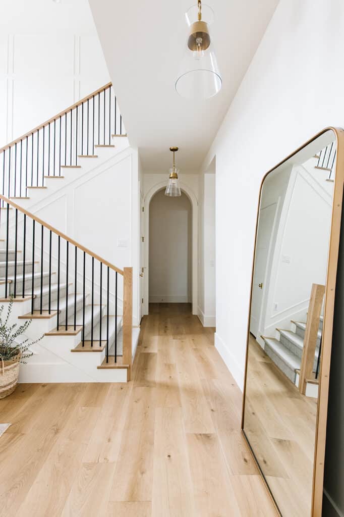 Natural carpeted staircase with simple newel posts 