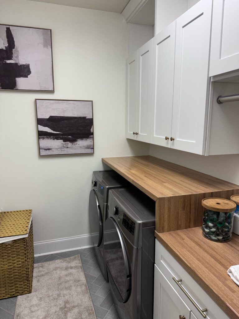 Completed Laundry Room Renovation With Wood Countertops And White Cabinets