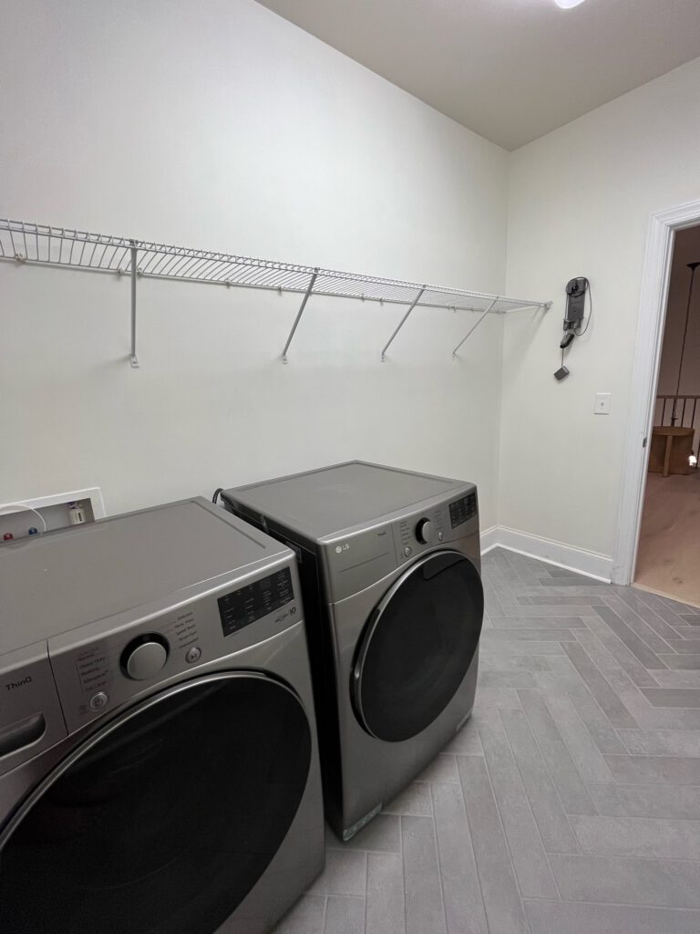 Herringbone Tile With New Washer And Dryer