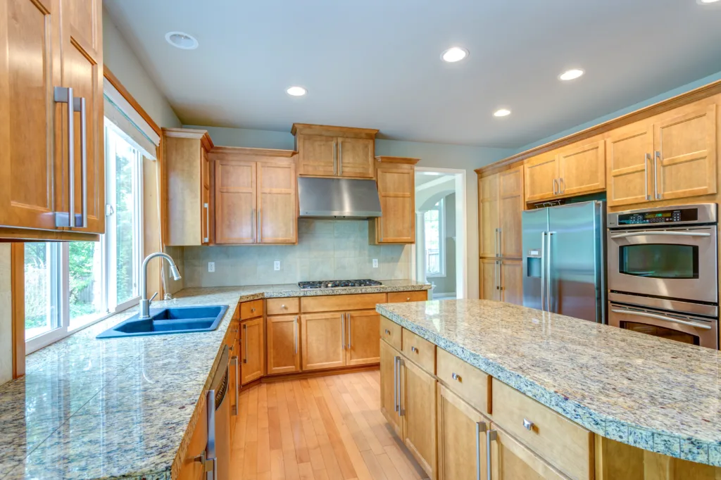 White Oak Cabinets with granite countertop in a dated kitchen