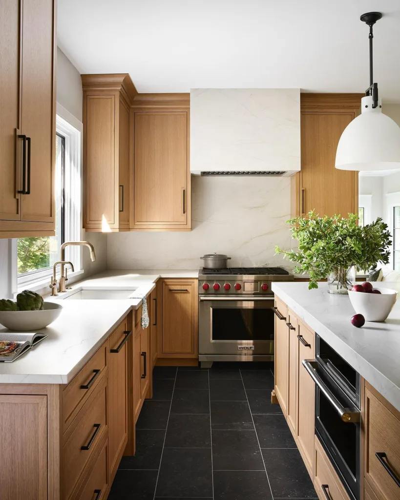 White oak cabinets with white countertops and wolf range