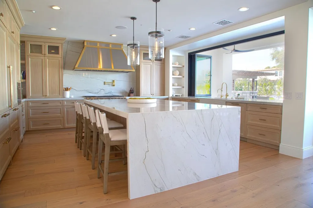 Large marble island in a white oak kitchen