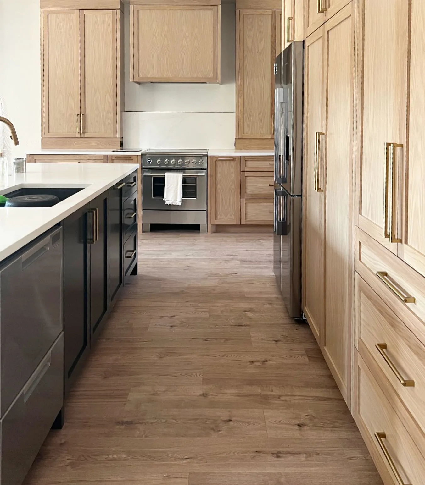 https://www.brickstonehome.com/wp-content/uploads/2023/01/Large-White-Oak-Paneled-Cabinets-jpg.webp