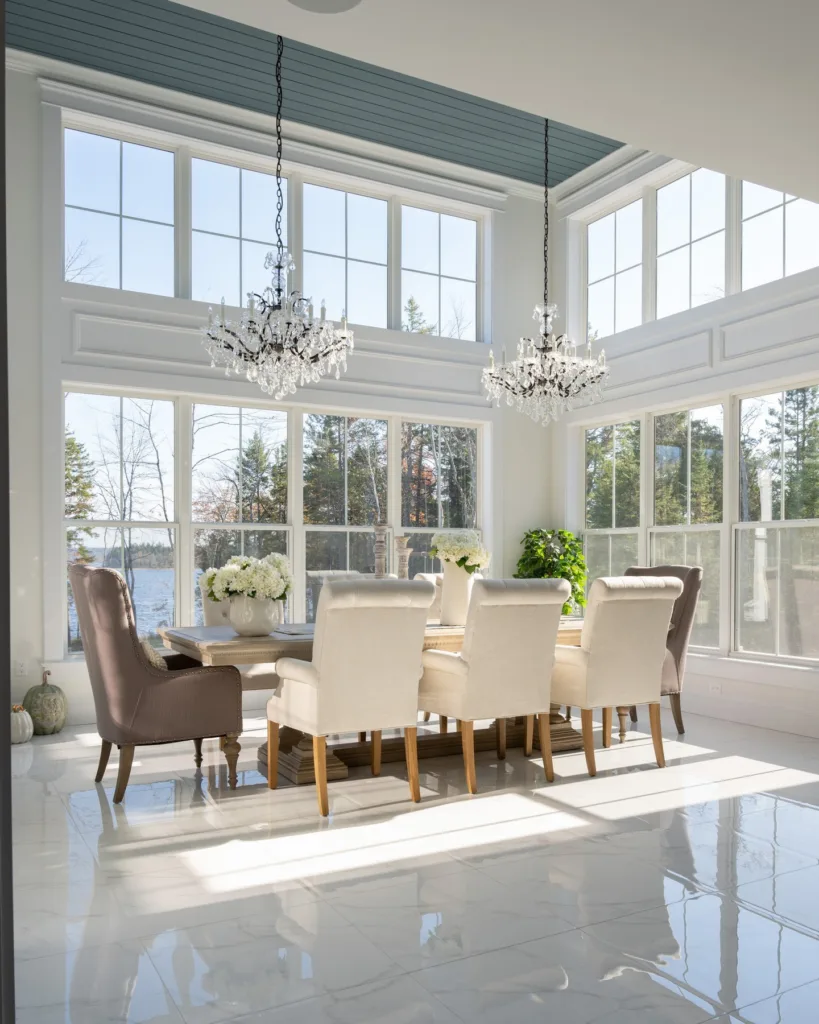 Blue painted shiplap on the ceiling in a white dining room with molding