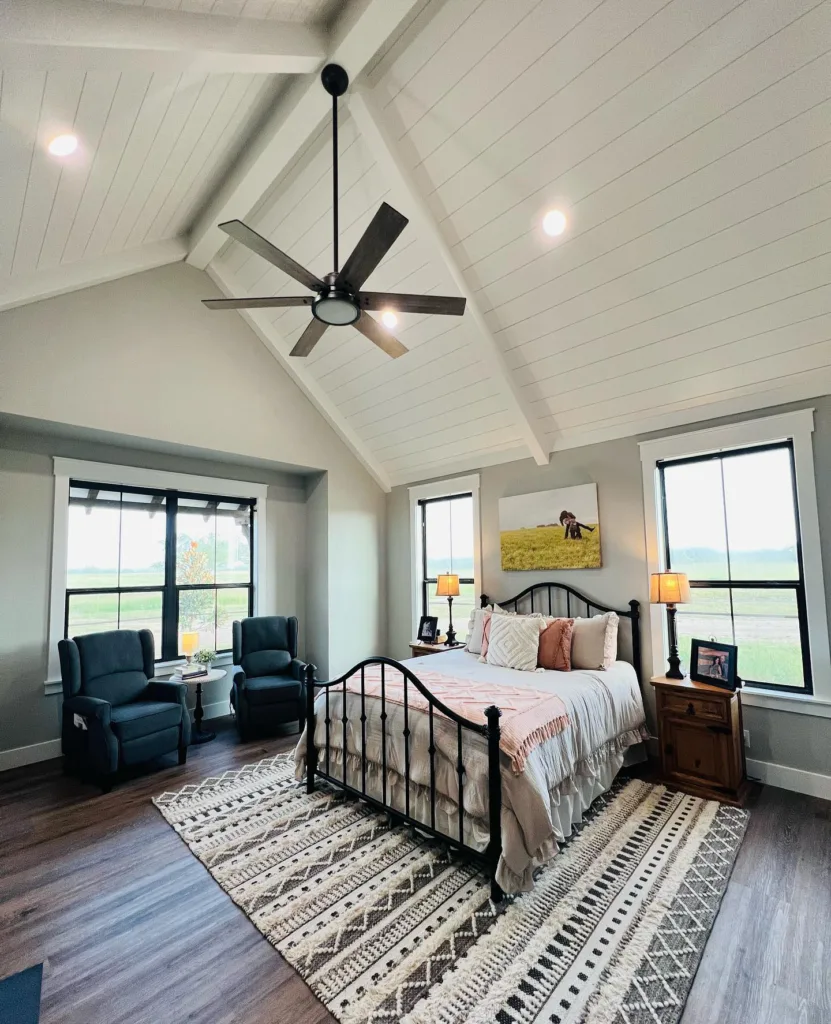 Bedroom shiplap vaulted ceiling painted white with a ceiling fan