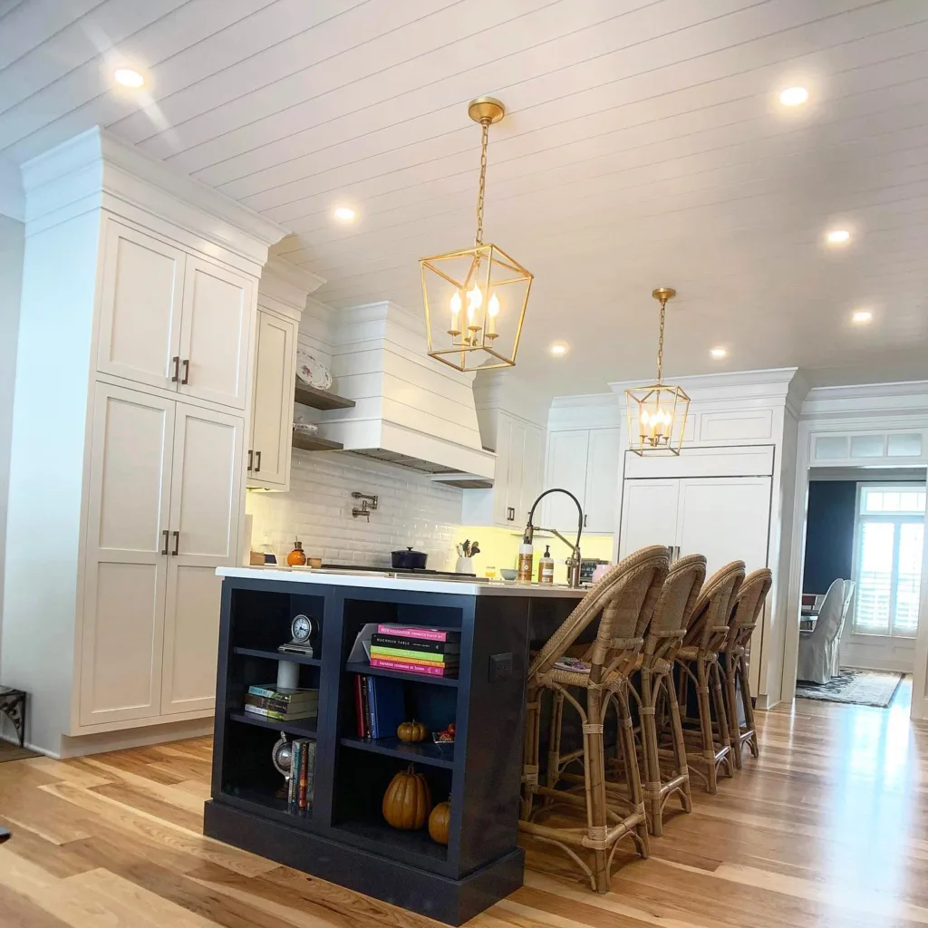 Modern kitchen with a navy island and white painted shiplap