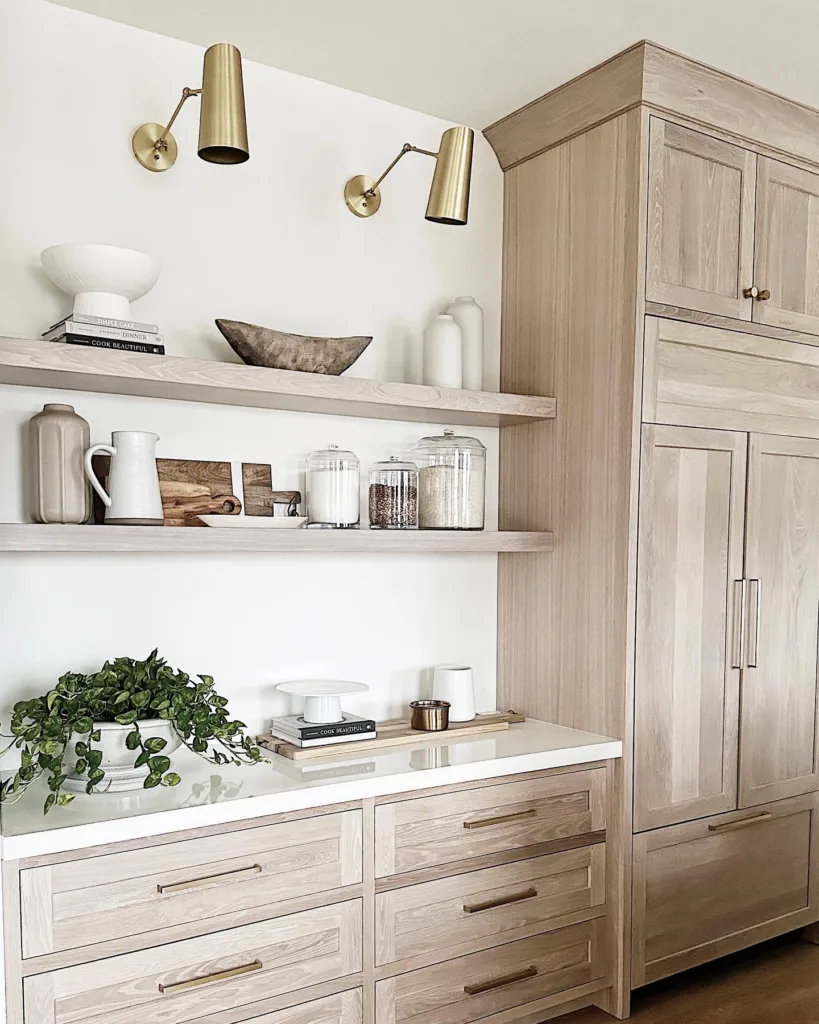White oak cabinetry with gold sconce