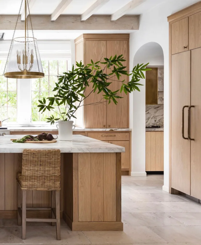 Black and gold hardware on white oak cabinets