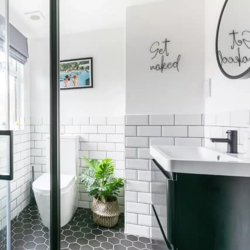 Bathroom With White Subway Tile Walls And Gray Grout With Black Hexagon Floor Tile