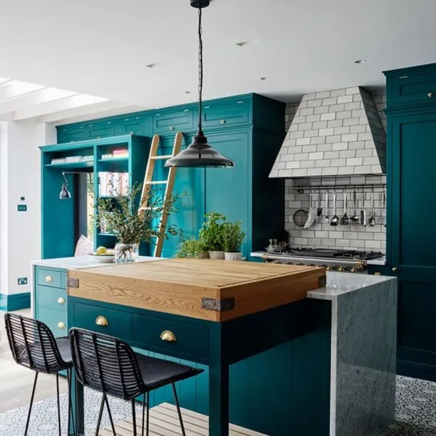 A Teal Kitchen With A Marble And Butcherblock Wood Island And Grey Backsplash