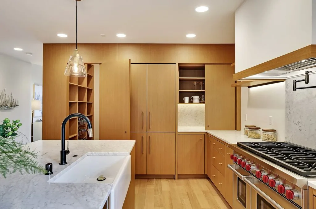  Kitchen Features Custom Inset Cabinets Clad In Teak To Mimic The Look Of Floor-To-Ceiling Built-Ins For A Sleek, Modern Space.