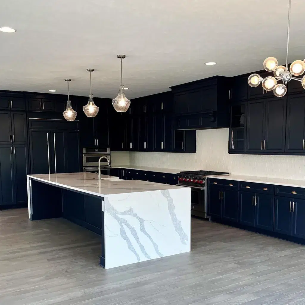 32 Waterfall Kitchen Island Ideas For Inspiration 24 A Large Black Kitchen With A White And Grey Quartz Waterfall Island