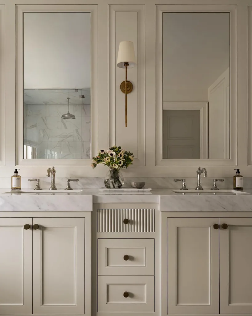 35 Bathroom Counter Decor Ideas 28 A Glass Vase Of Flowers On A Marble Tray On A Beige Vanity With Marble Countertops