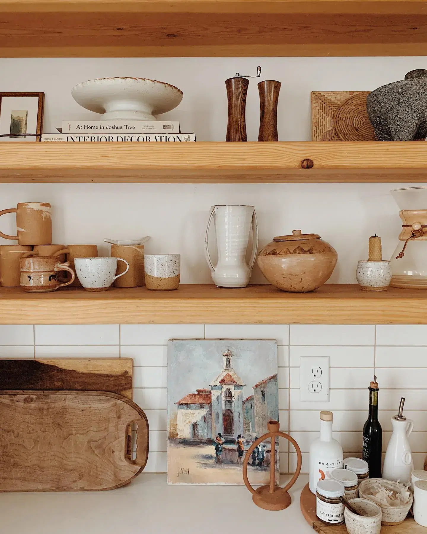 Light butcher block wood shelves and subway tile backsplash