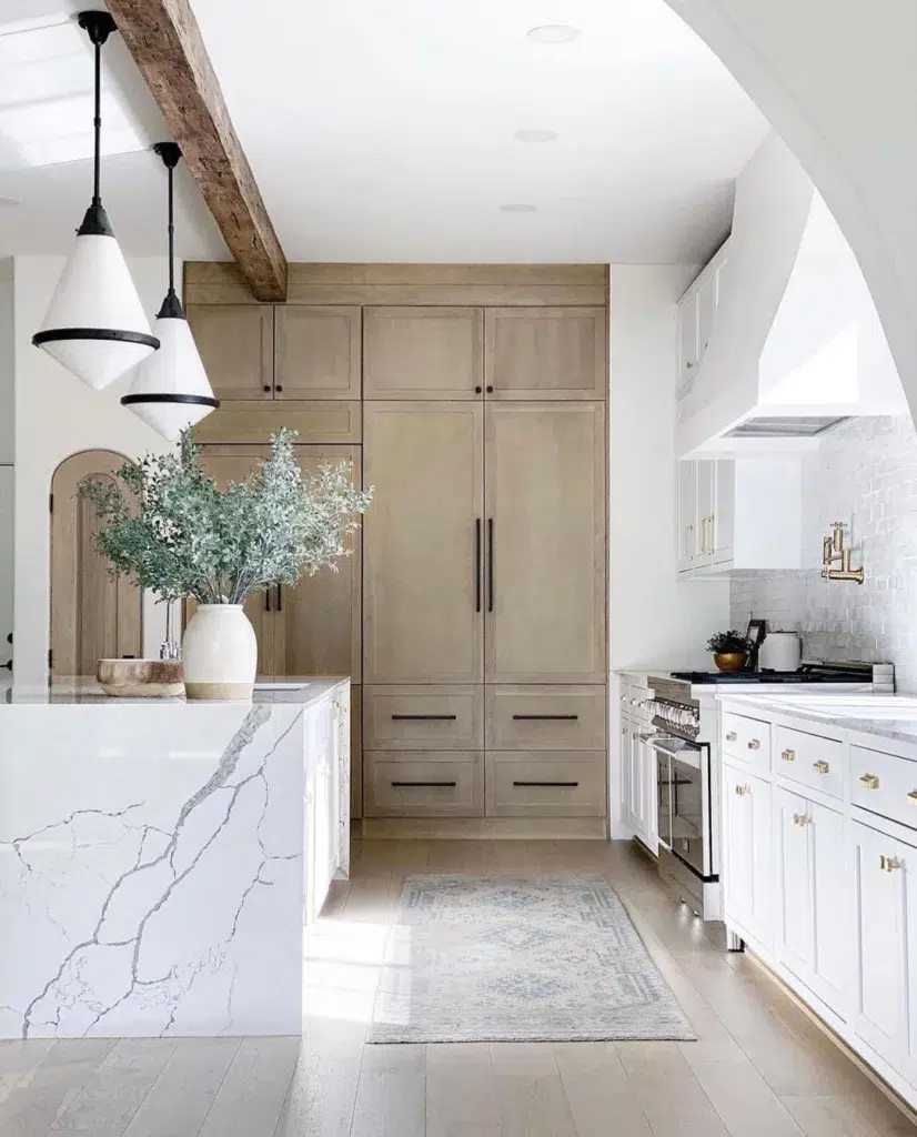 White Oak And White Painted Cabinets With A White Quartz Island With A Waterfall Edge
