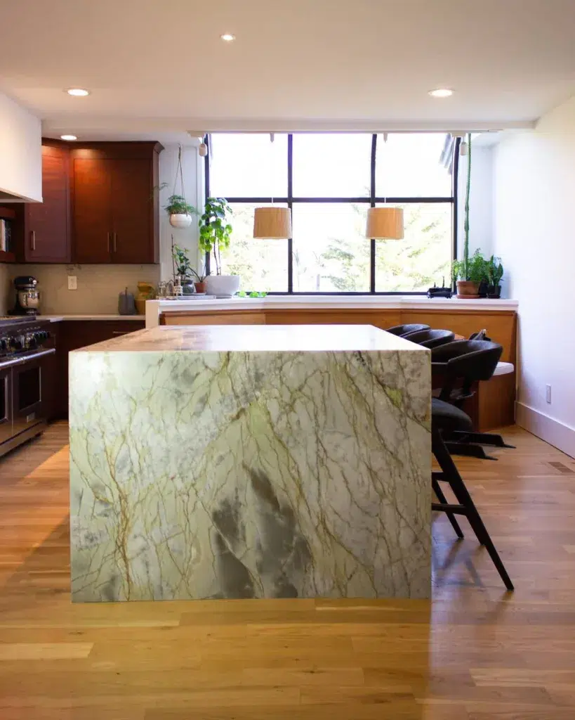 32 Waterfall Kitchen Island Ideas For Inspiration 28 A Grey Granite Waterfall Island With Beige And Brown Veins