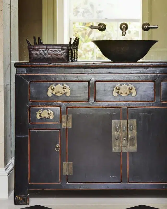 35 Bathroom Counter Decor Ideas 19 A Metal Bathroom Vanity With A Matching Bronze Basket On Top As Decor