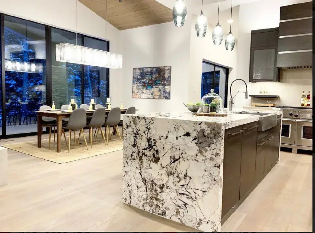 32 Waterfall Kitchen Island Ideas For Inspiration 10 A Busy Marble With Lots Of Veining Is Installed On This Waterfall Kitchen Island