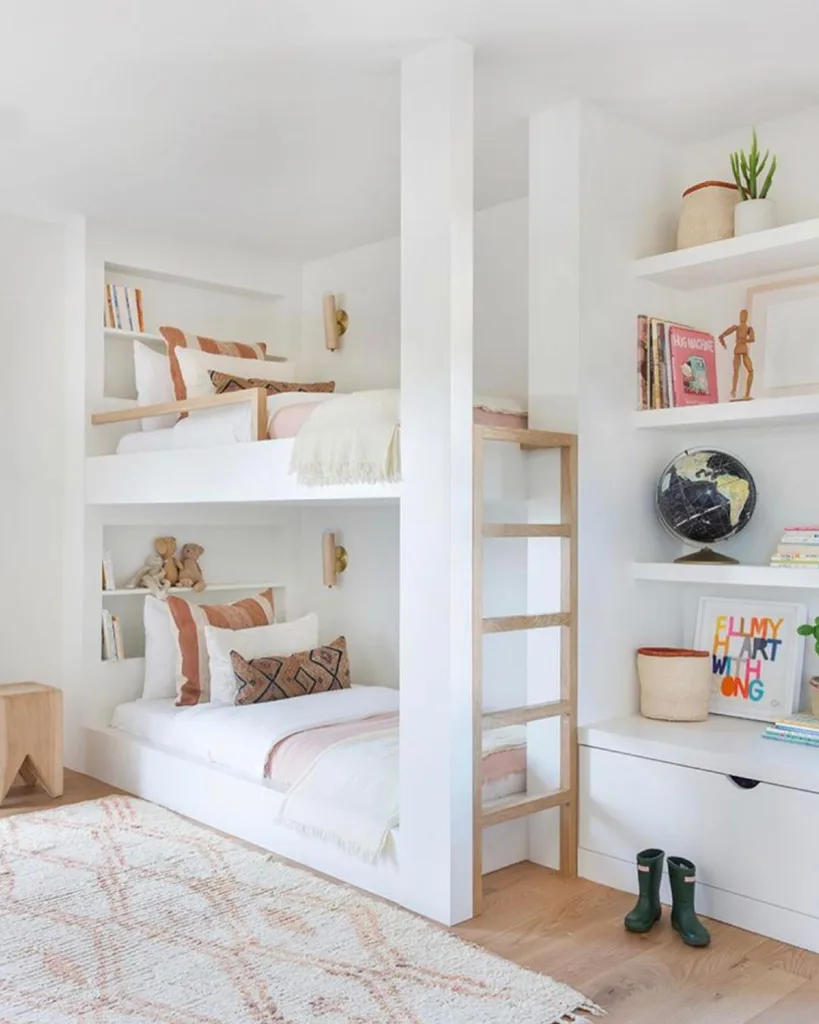 Built-In White Bunk Beds With A Natural Wood Ladder