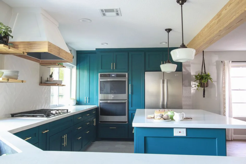 Green Teal Cabinets With A Blue Island And White Countertops