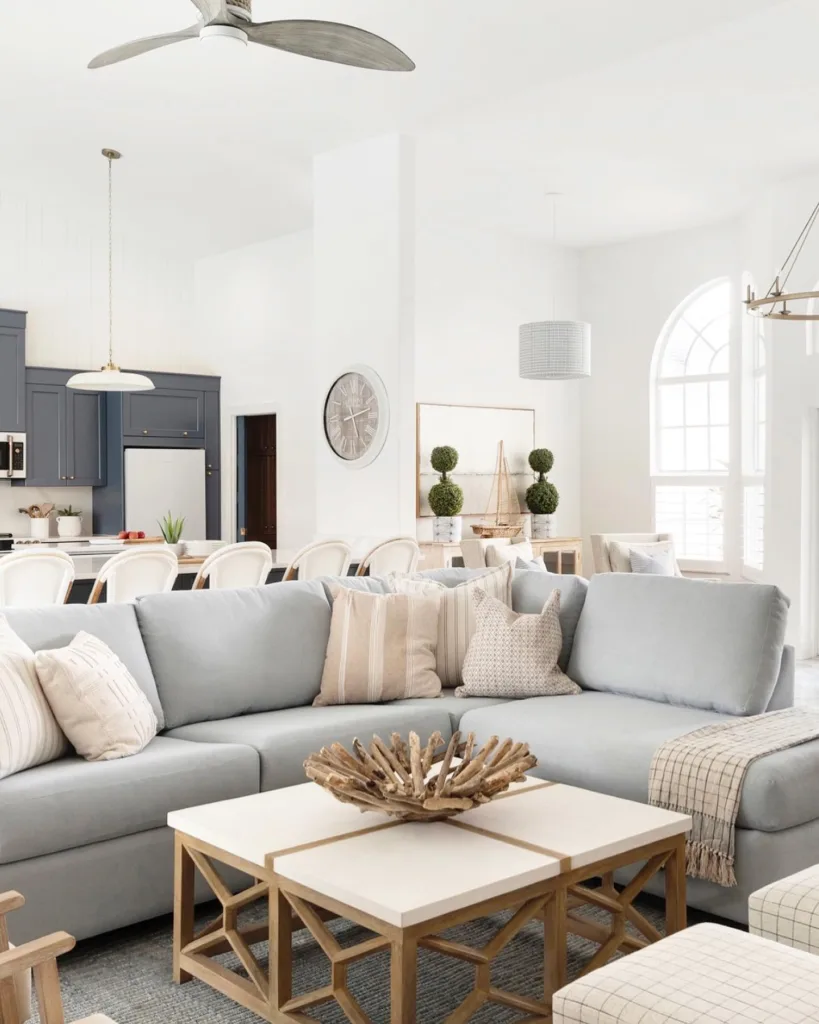 A Light Grey Sofa With Neutral Furniture Accents In A White Coastal Living Room