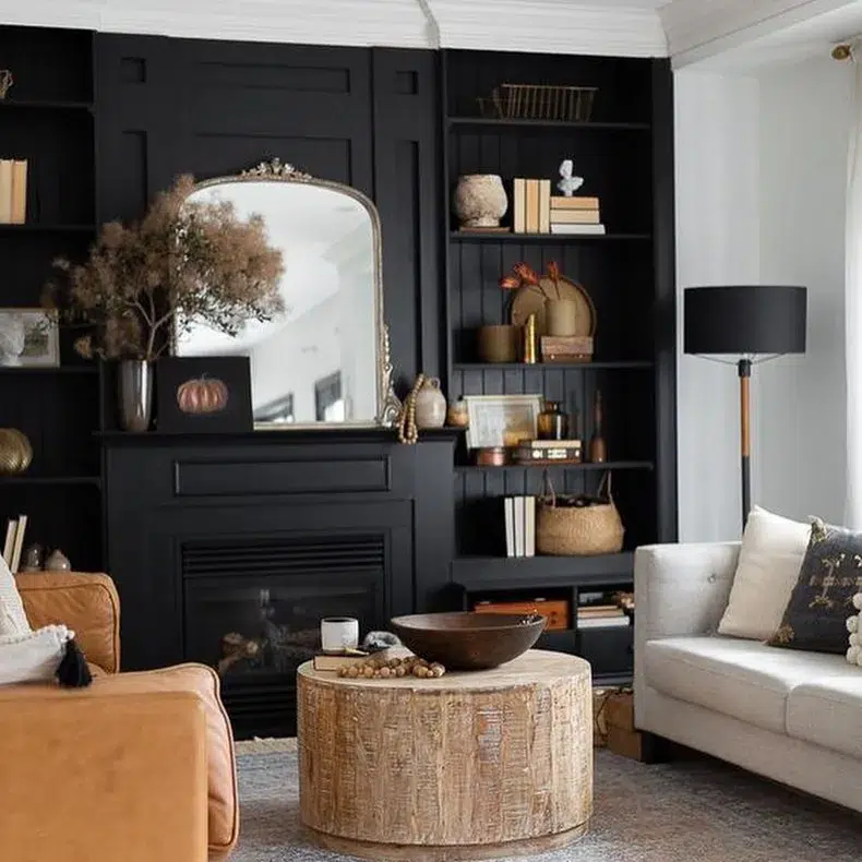 A Black Living Room With A Filigree Mirror And Built-Ins