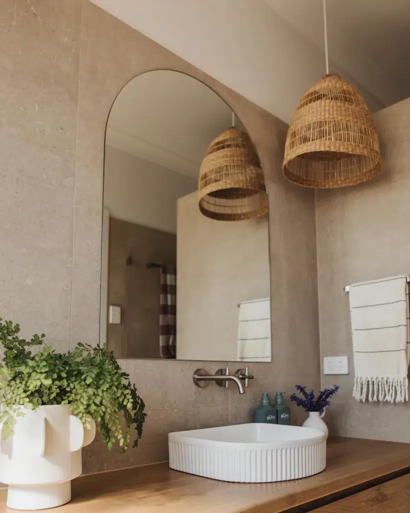 35 Bathroom Counter Decor Ideas 30 A Large Plant In A White Planter That Matches The Porcelain Sink On This Wood Vanity