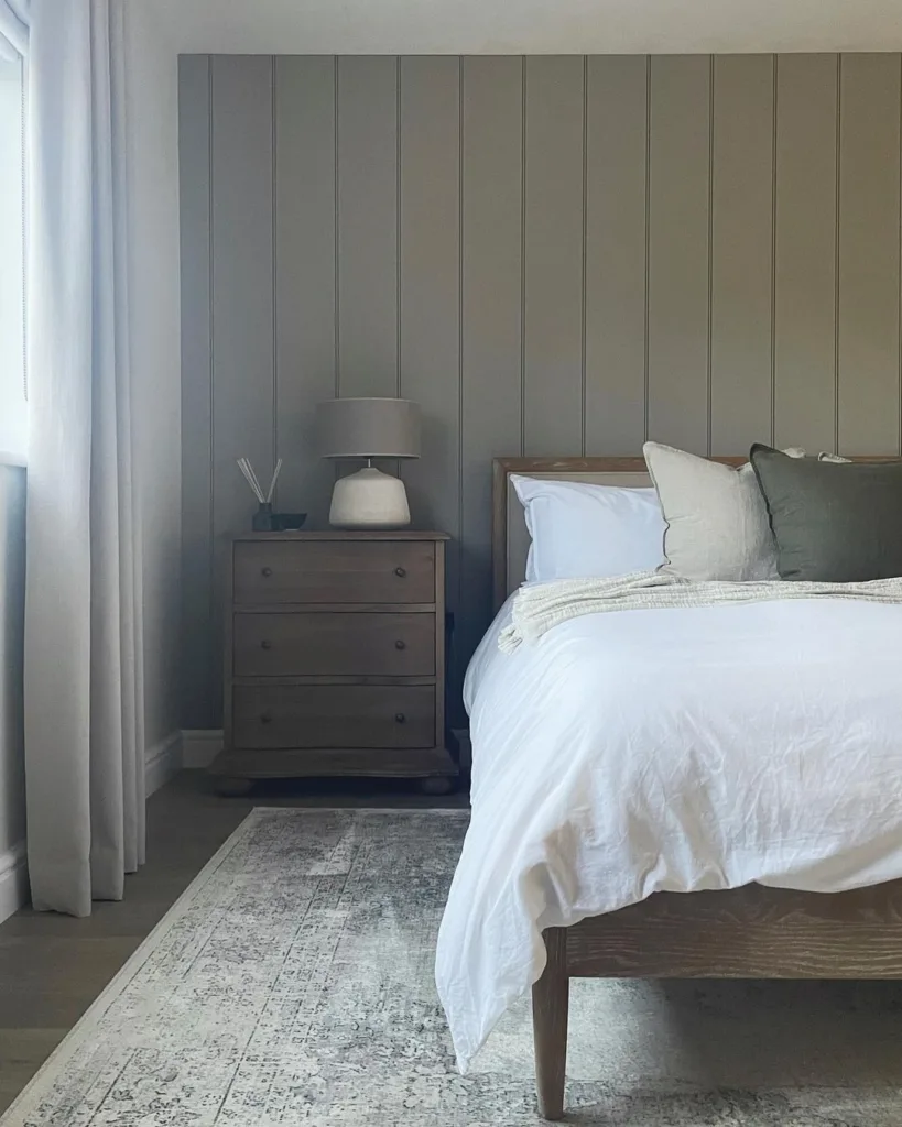 Vertical Shiplap Behind The Headboard Of A Wood Bed On A Patterned Rug