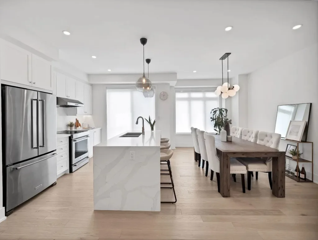 32 Waterfall Kitchen Island Ideas For Inspiration 14 A White Quartz Waterfall Kitchen Island With Light Wood Floors