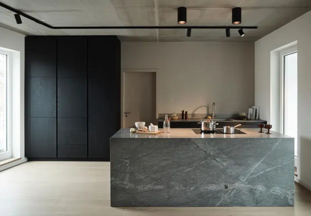 32 Floor To Ceiling Cabinets Ideas To Maximize Storage 22 Opening Onto The Living Room, The Kitchen Features A Pure Concrete Ceiling And A Light-Coloured Wooden Floor.