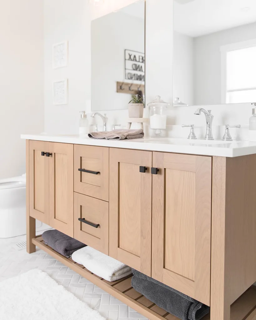 35 Bathroom Counter Decor Ideas 35 A White Oak Bathroom Vanity With Light Wood Decor And A Beige Towel On The Countertop