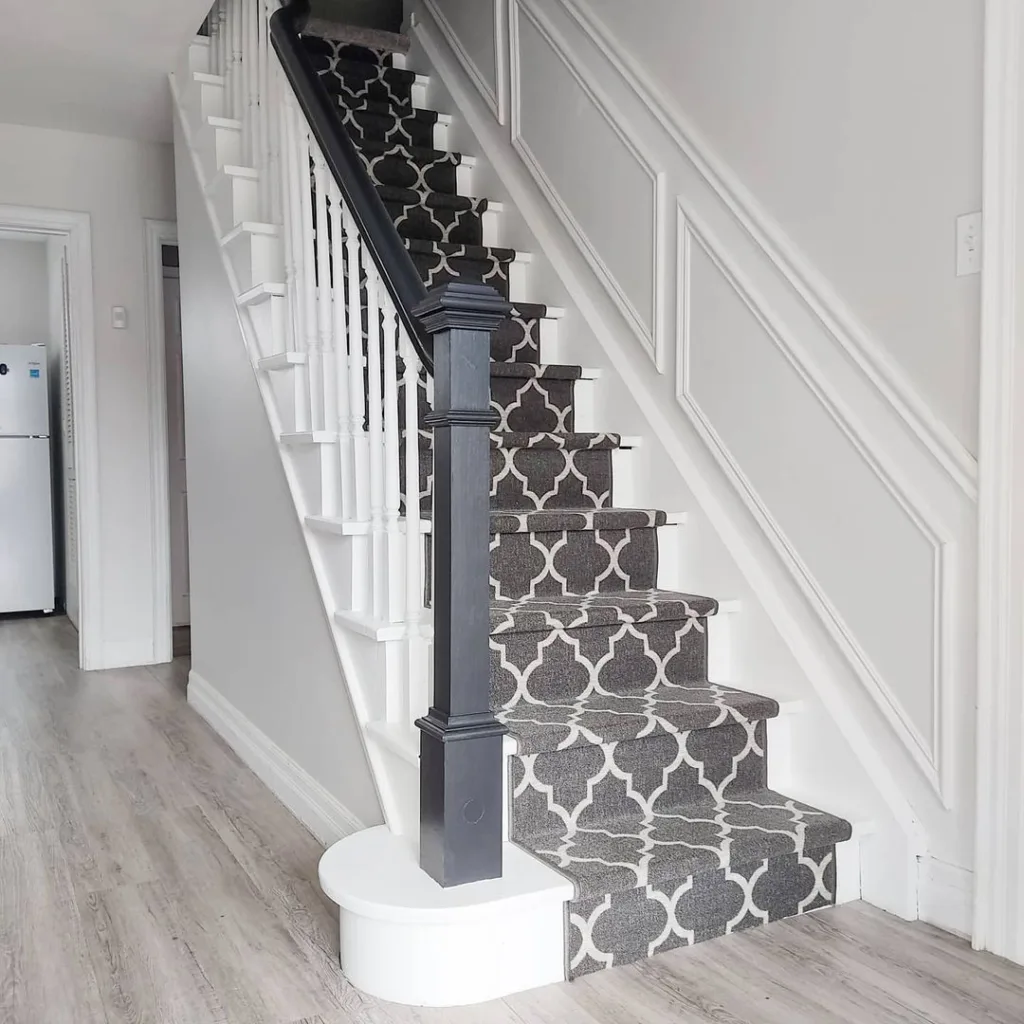 A Grey And White Carpet Runner On A Black And White Staircase