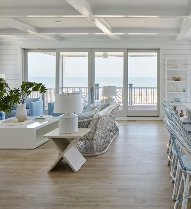 31 Coastal Beach-Themed Living Room Ideas 6 A Beach Living Room With Large Sliding Doors Leading To A Balcony From The Living Room With Blue Accents