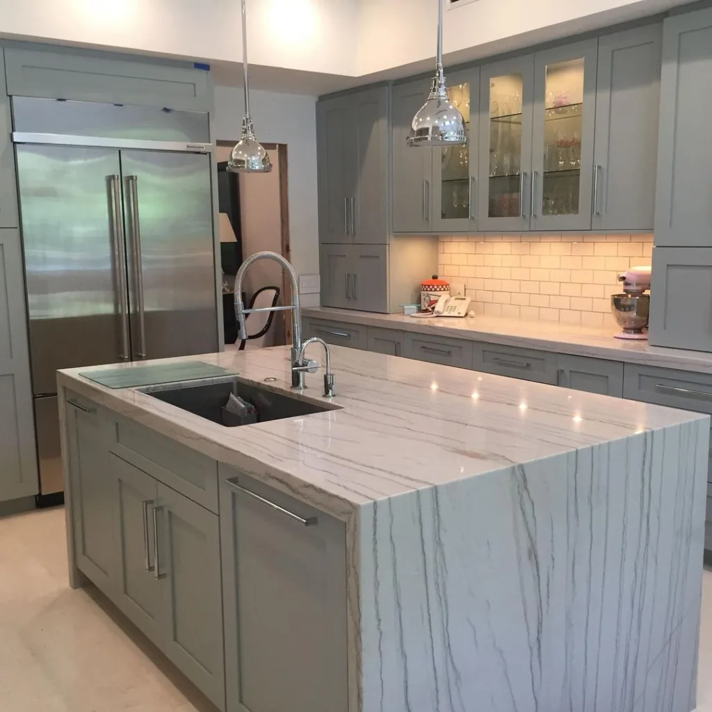 32 Waterfall Kitchen Island Ideas For Inspiration 11 A Grey Modern Waterfall Kitchen Island With A Stainless Steel Sink