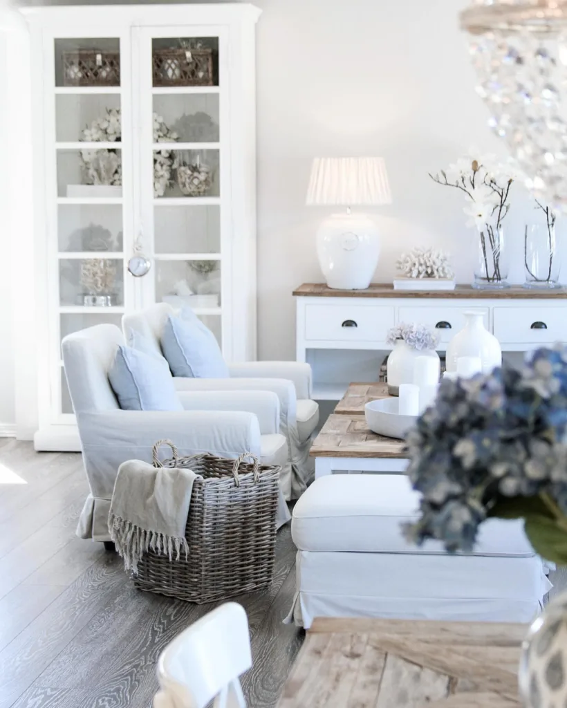 31 Coastal Beach-Themed Living Room Ideas 18 Blue Accent Chairs Around A Wood Coffee Table In A Beach Themed Living Room With Wood Floors
