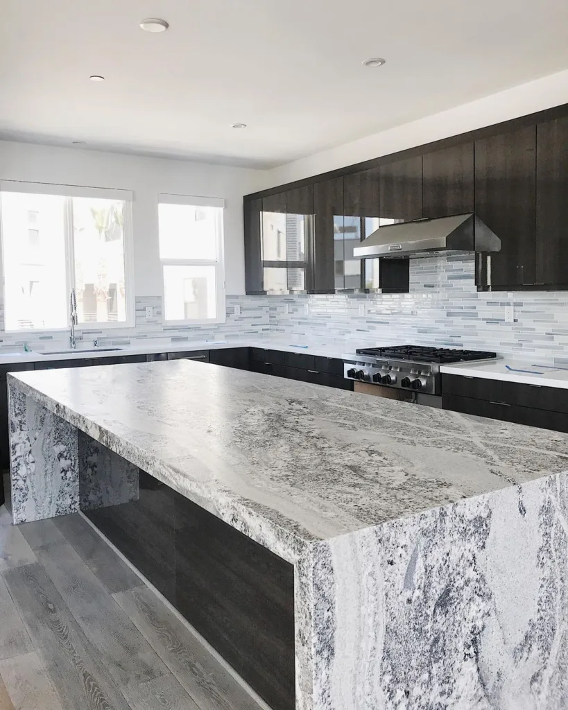 A Waterfall Edge And Extra Thick Slab Used In In Kitchen