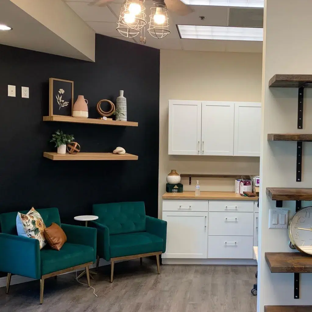 34 Black Accent Wall Ideas For Stunning Contrast 5 Black Accent Wall Next To A Small Kitchen With Green Chairs In Front