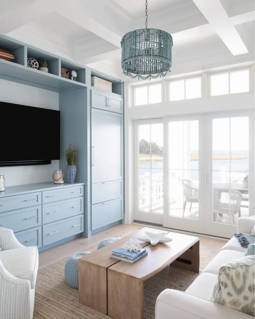 31 Coastal Beach-Themed Living Room Ideas 1 Light Blue Cabinets Around The Tv In A Beach Themed Living Room With A White Sofa And Wood Coffee Table