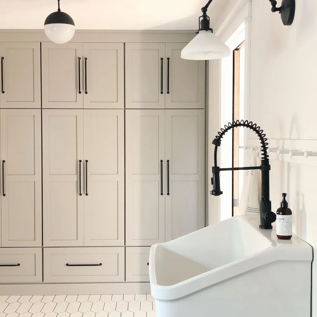 32 Floor To Ceiling Cabinets Ideas To Maximize Storage 13 White Floor To Ceiling Cabinet Used In A Washroom With A White Sink And Black Tap.