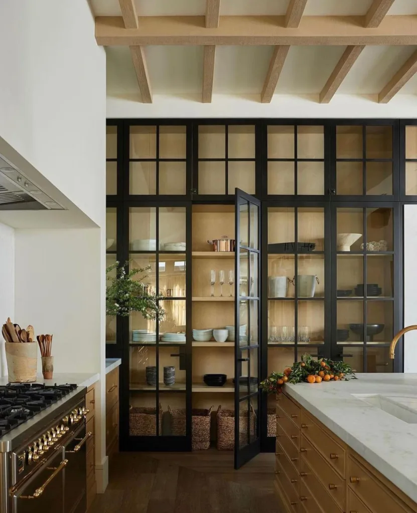 32 Floor To Ceiling Cabinets Ideas To Maximize Storage 17 Black Kitchen Cabinets With Glass Doors Stretching From The Floor To The Ceiling. Displayed Inside Are Various Dishes, Glasses, And Bowls.