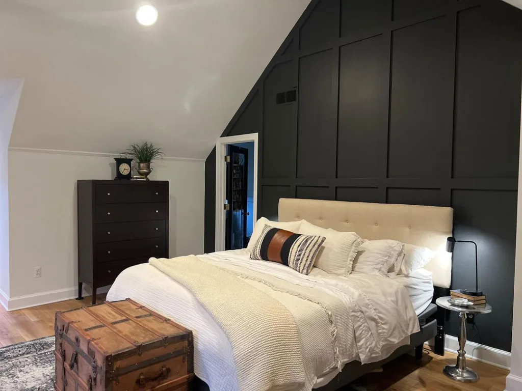 Sloped Ceiling Bedroom With A Black Accent Wall Behind The Headboard