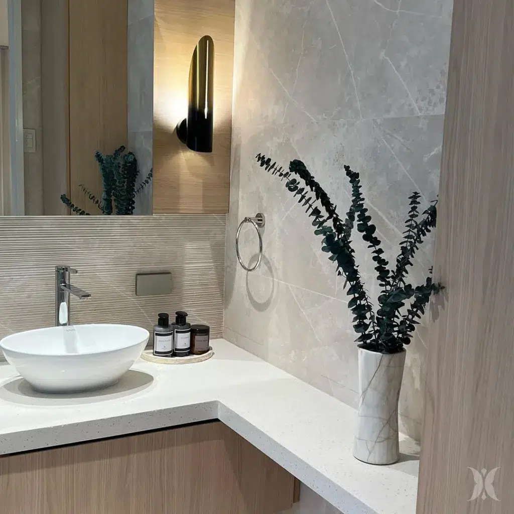 35 Bathroom Counter Decor Ideas 16 A Marble Vase On The Bathroom Counter Matches The Gray Backsplash