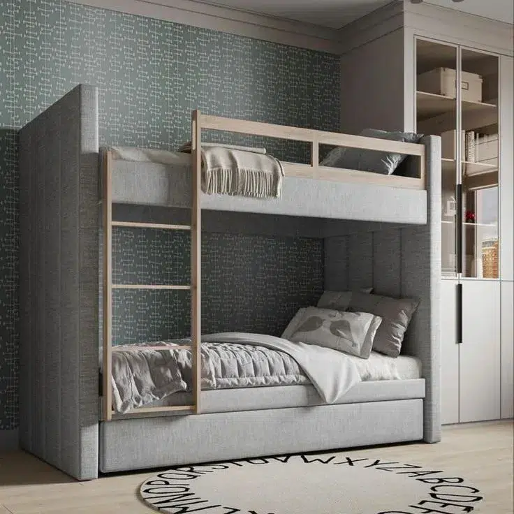 A Grey Upholstered Built In Bunk With With Wood Railings